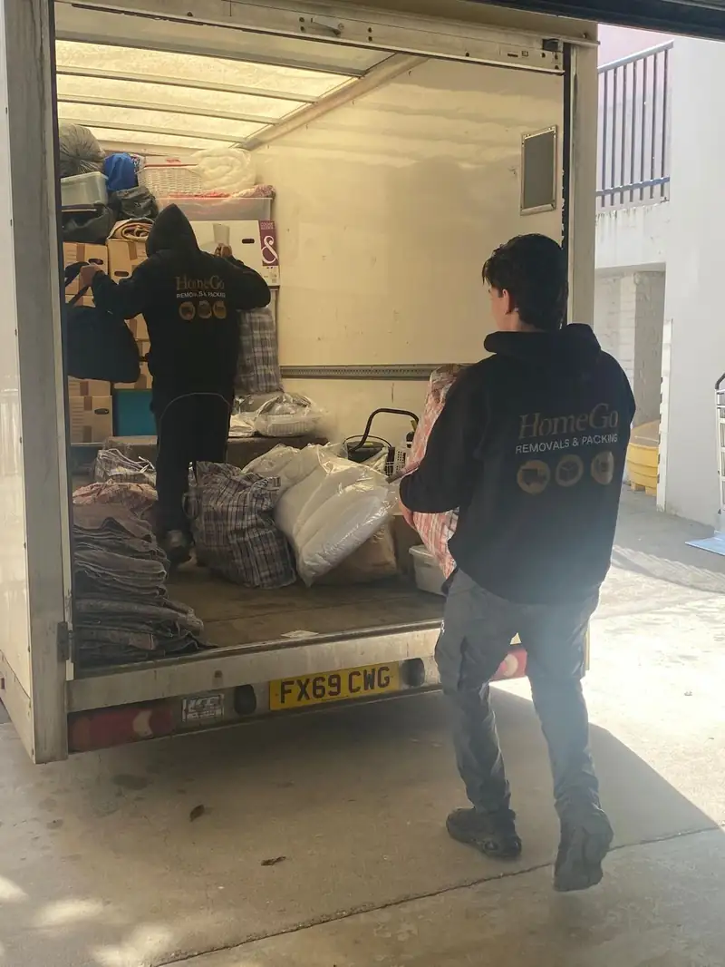 HomeGo removals van packed professionally with blankets and straps — packing services UK